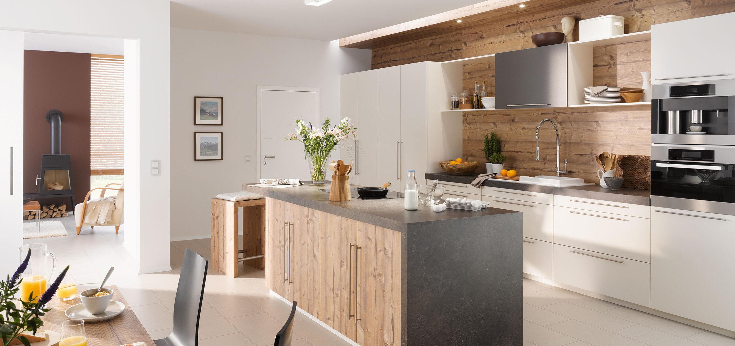 Impressionen einer Küche mit Esszimmer mit hellen Holzmöbeln und dunklen und weißen Fronten im Kontrast