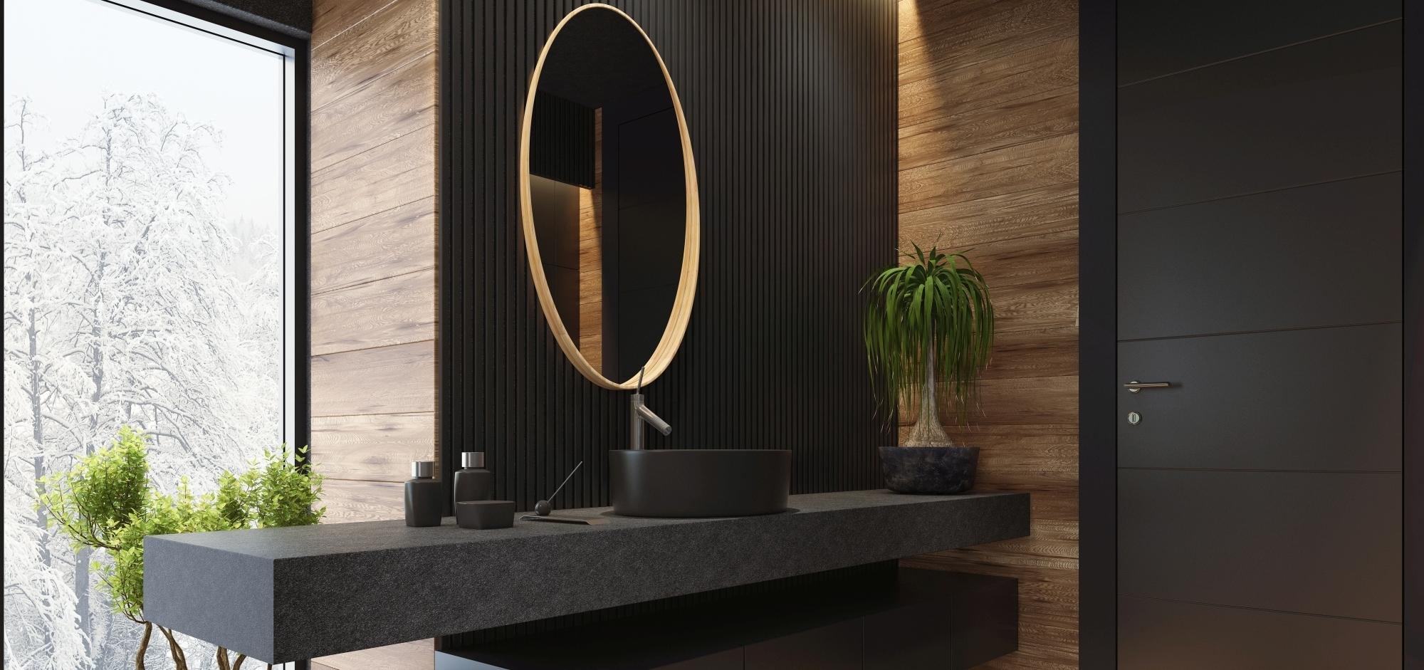 Lichtdurchflutetes Badezimmer mit dunkler schwarzer Waschtischarbeitsplatte, die über die Wand hinausragt und hängendem Unterschrank, runder Spiegel, Wandkontrast in Holz.